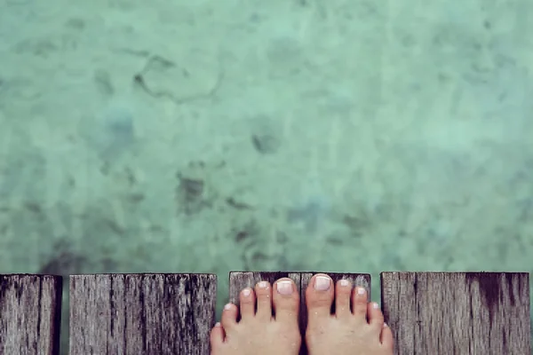 Woman sandy feet on the beach