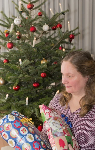 Woman gets in front of Christmas gifts