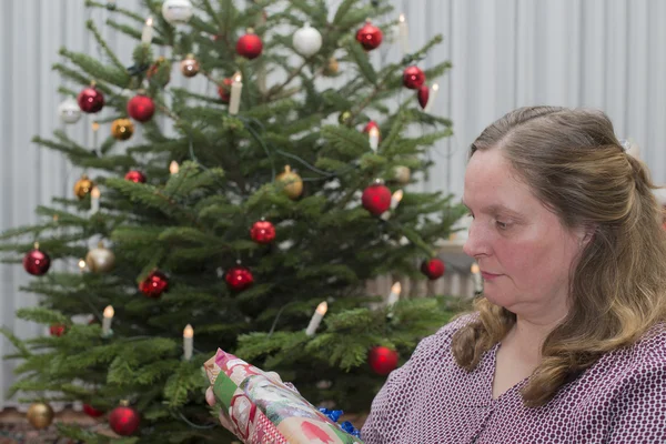 Woman gets in front of Christmas gifts