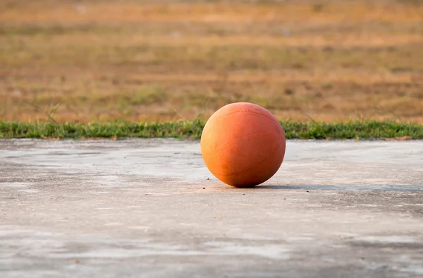 The old basketball ball on the floor