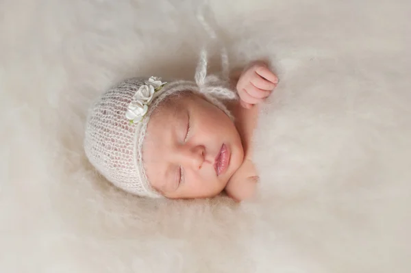 Newborn Baby Girl in Knitted Bonnet