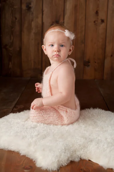 Baby Girl Wearing a Knitted Romper and Headband