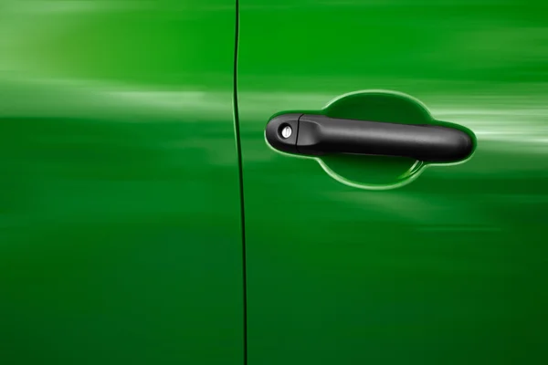 Driver\'s door of a green car