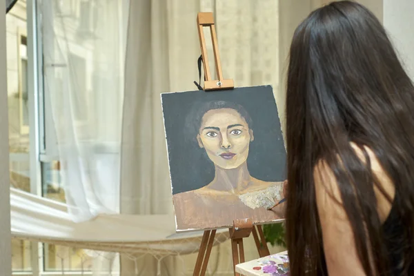 Artist paints picture on canvas