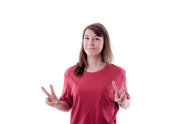 Young woman showing two fingers, positive or peace gesture, on w