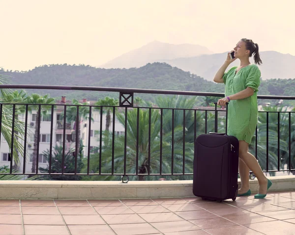 Woman in vacation with suitcase in hand