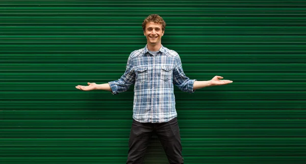 Young blonde man casual dressed standing against green backgroun