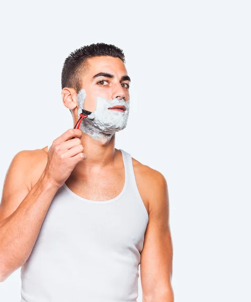 Handsome man shaving his beard