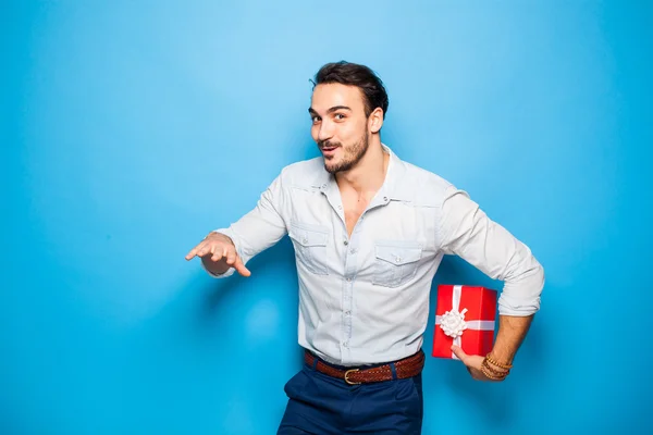 Handsome adult man on blue background with christmas gift