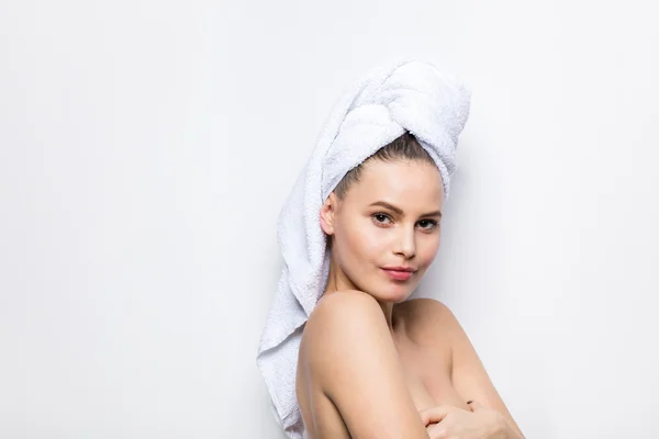 Beautiful young woman with bath towel on head