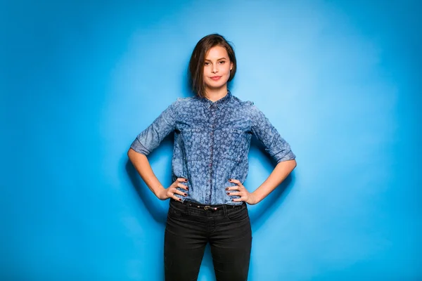 Young woman casual dressed on blue background