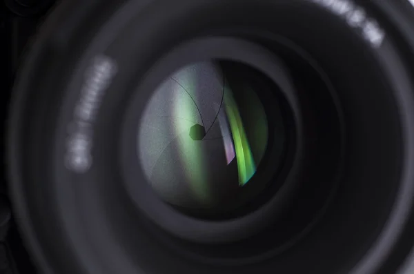 Camera lens close-up on white background