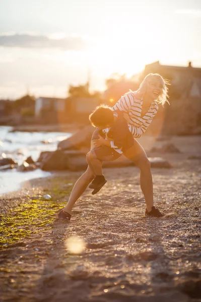 Beautiful woman with a child on the beach.