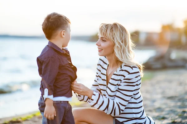 Beautiful boy with a woman relaxing on the beach.