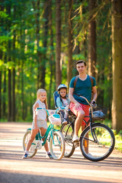 Happy family biking outdoors at the park
