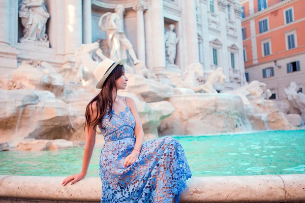 Beautiful woman near Trevi Fountain, Rome, Italy. Happy girl enjoy italian vacation holiday in Europe.
