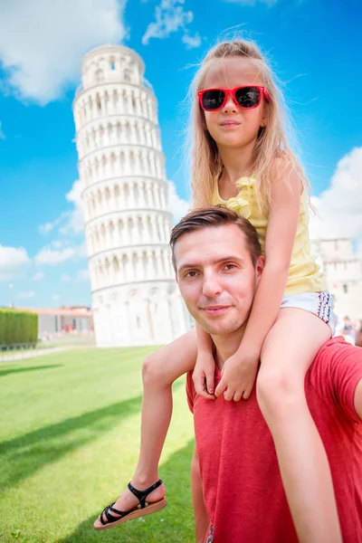 Family portrait background the Learning Tower in Pisa. Pisa - travel to famous places in Europe.