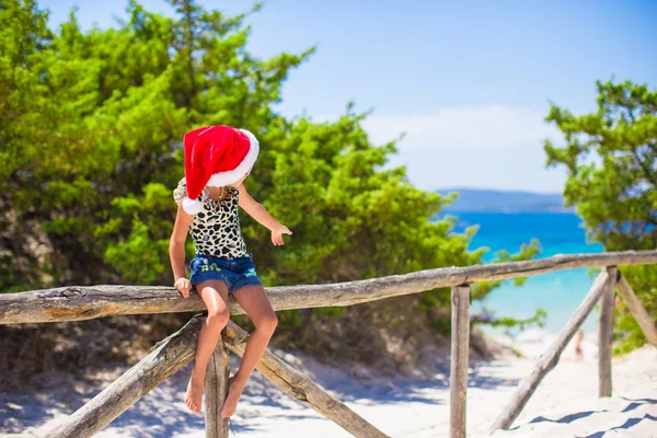 Adorable little baby girl in christmas hat during summer vacation