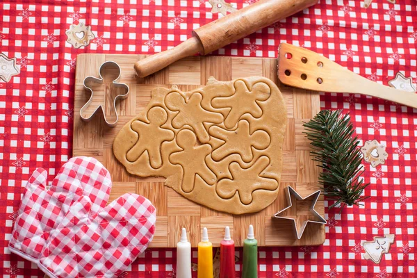 Cutting gingerbread cookie dough for Christmas