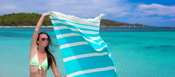 Happy woman have fun with beach towel and very happy