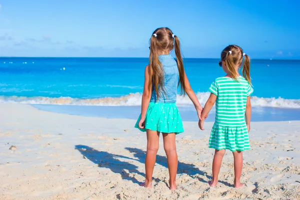 Little adorable girls during tropical beach vacation