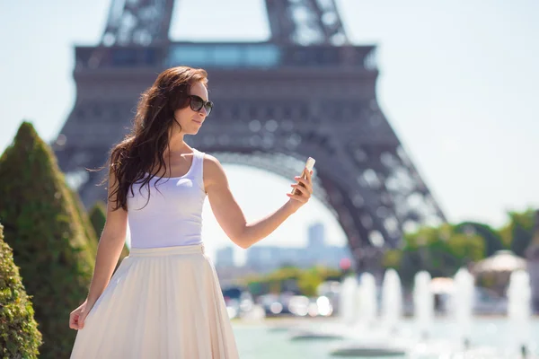 Beautiful woman in Paris background the Eiffel tower during summer vacation
