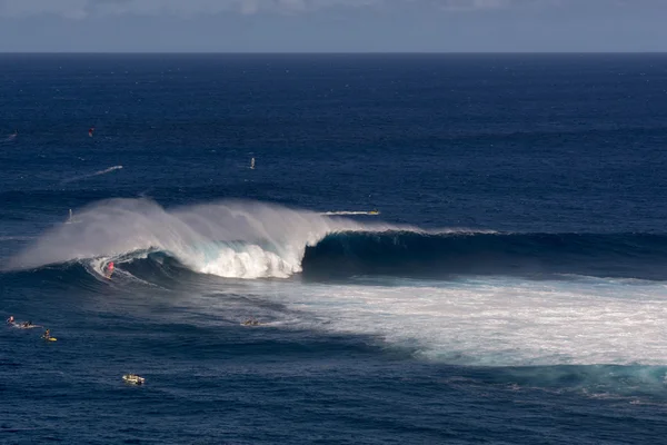 Wind surfer on wave at Peahi or Jaws surf break, Maui, Hawaii, USA