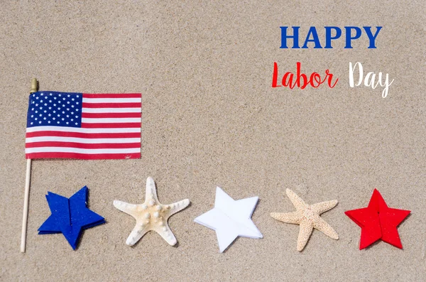 Labor Day with American flag starfishes on the sandy beach