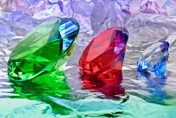 Precious stones,jewelry on the background of silver foil