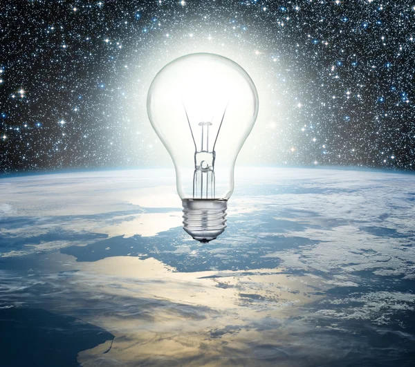 Light bulb over Earth on a background of the universe