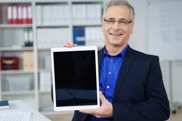 Confident businessman displaying a blank tablet