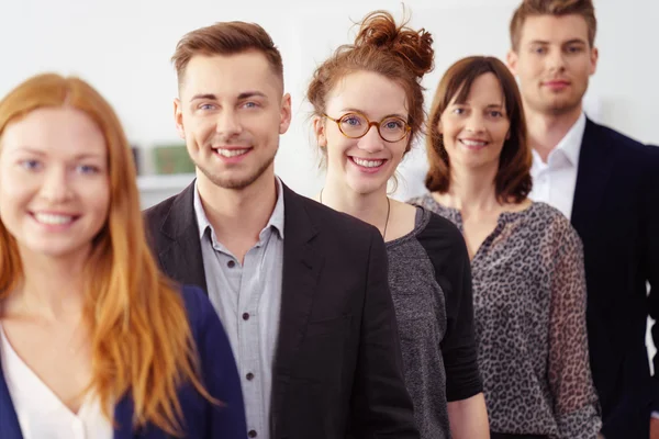 Smiling group of young professionals in office