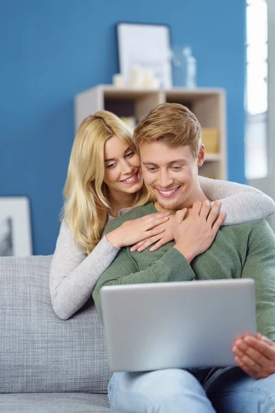 Happy loving young couple browsing the web