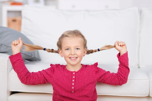 Girl pulling her pigtails