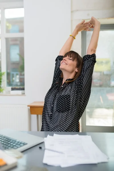 Businesswoman stretching