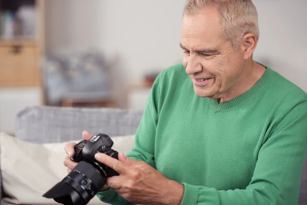 Middle Aged Man Viewing Captured Pictures on DSLR