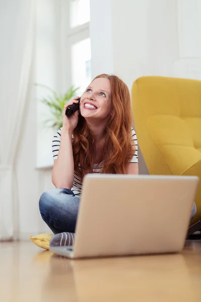 Happy Woman with Laptop Talking on Phone