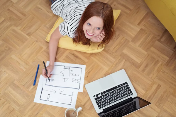 Woman Lying on the Floor Thinking a Design to Draw