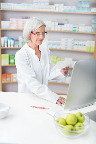 Senior lady pharmacist working in a pharmacy