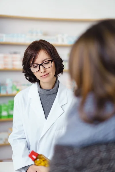 Pharmacist Helping a Customer in Buying Medicines