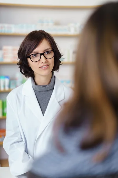 Pharmacist Talking to a Customer at the Counter