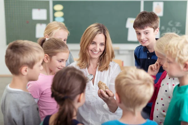 Cheerful Teacher Explaining Something to Kids