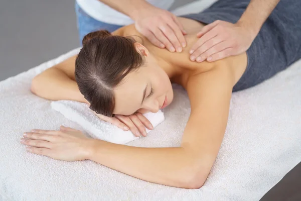 Woman Enjoying the Massage Therapy on her Upper Back with eyes closed