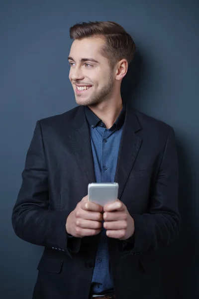 Happy young man using his mobile phone