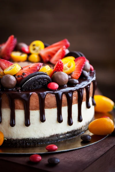 Chocolate cheesecake decorated with fresh fruits