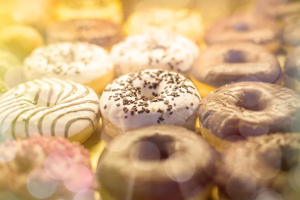 Many different donuts found in a bakery