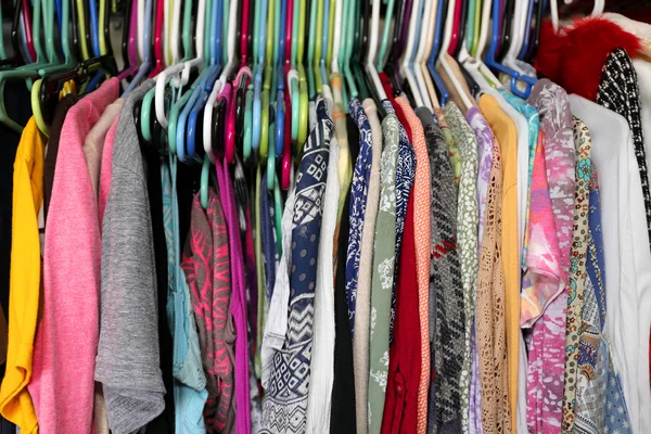 Colorful Woman\'s Clothing Hanging in a Messy Closet