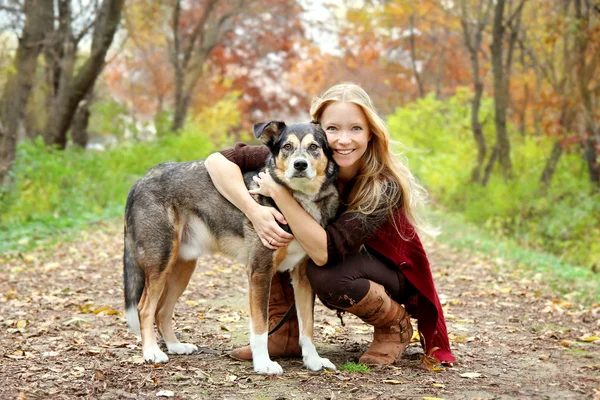 Woman and Dog in Woods in Autumn