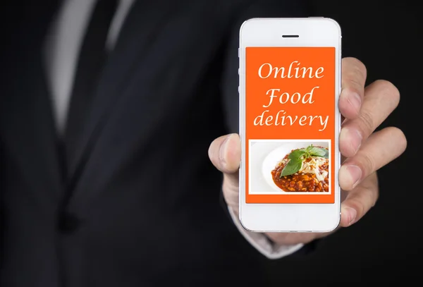 Businessman hand Holding Smartphone with Online food delivery on screen.lifestyle concept