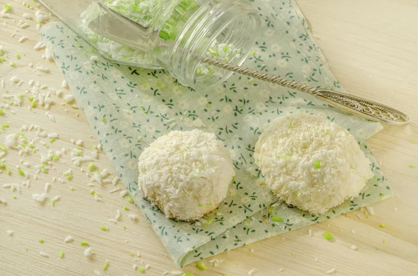 Twoo cookies with coconut flakes on cotton cloth. Near glass jar.